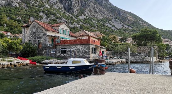 a boat docked at a small village