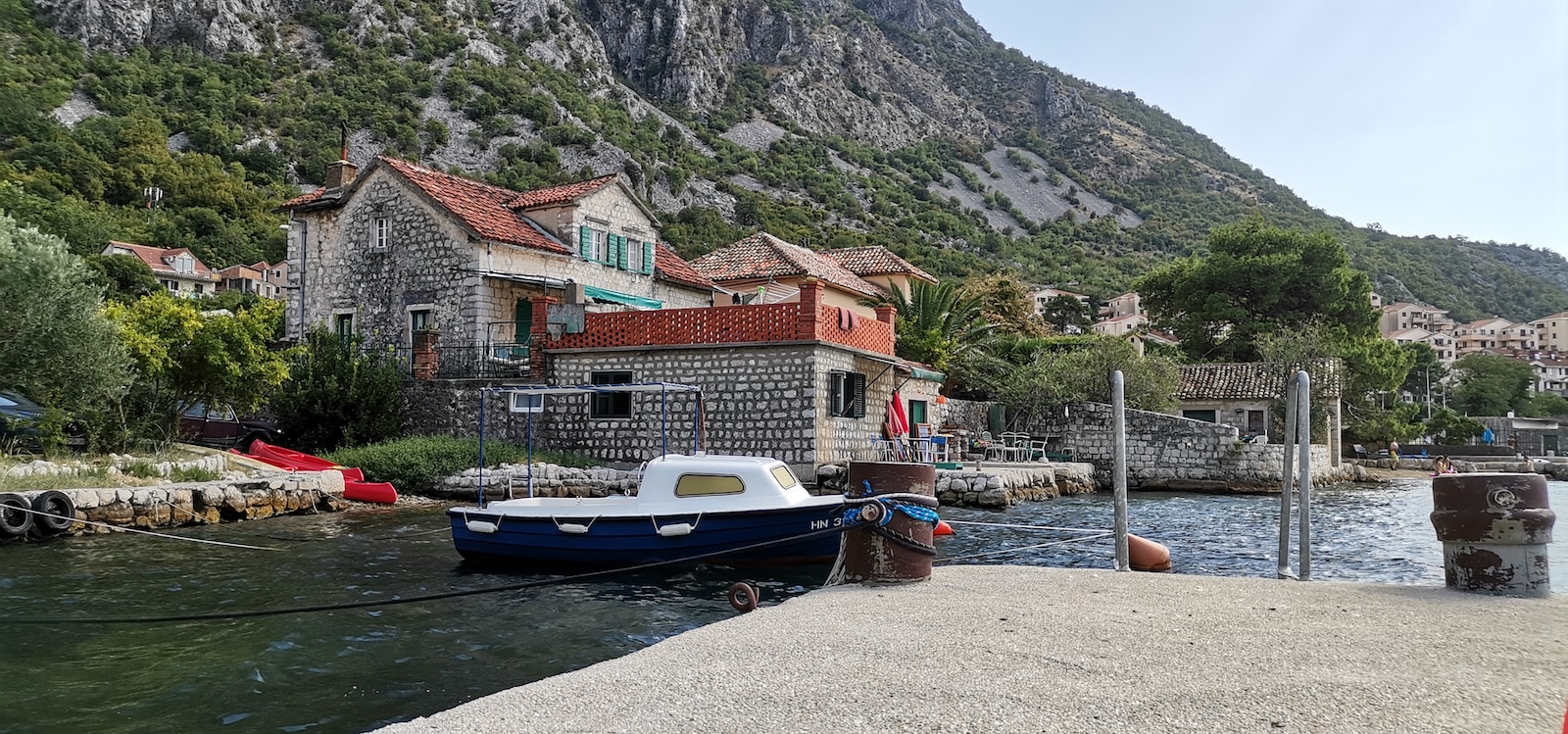 a boat docked at a small village